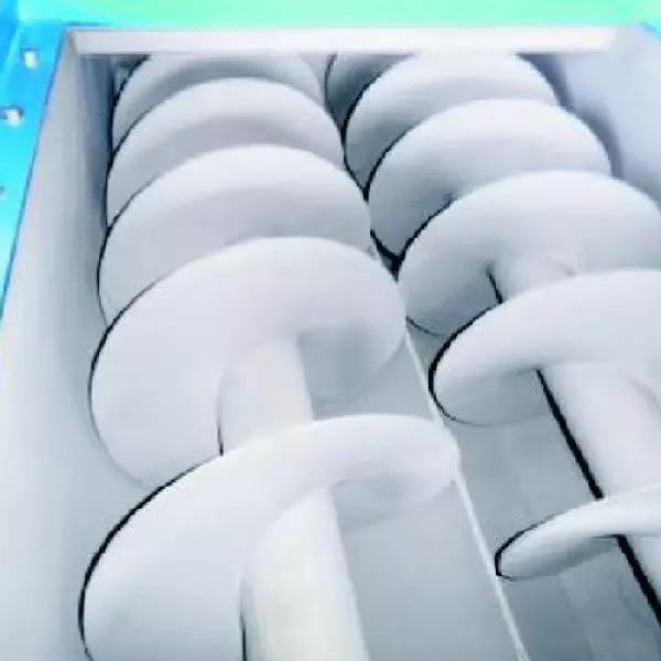 Stainless Steel Inclined Screw Conveyor Installed At An Industrial Site