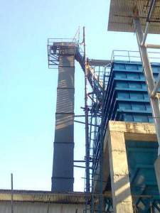 Belt Type Bucket Elevator System Installed In Industrial Setting Showing Buckets Attached To A Moving Belt