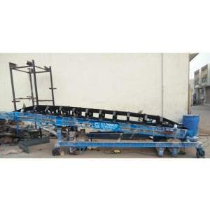 Side View Of Industrial Trough Belt Conveyor Showing Curved Belt And Roller Supports
