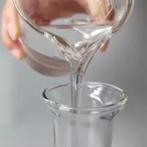 Container Filled With Clear Paraffin Oil Used In Industrial Applications