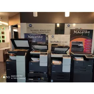 Photocopier Machine In An Office Setting Showing Paper Trays And Control Panel