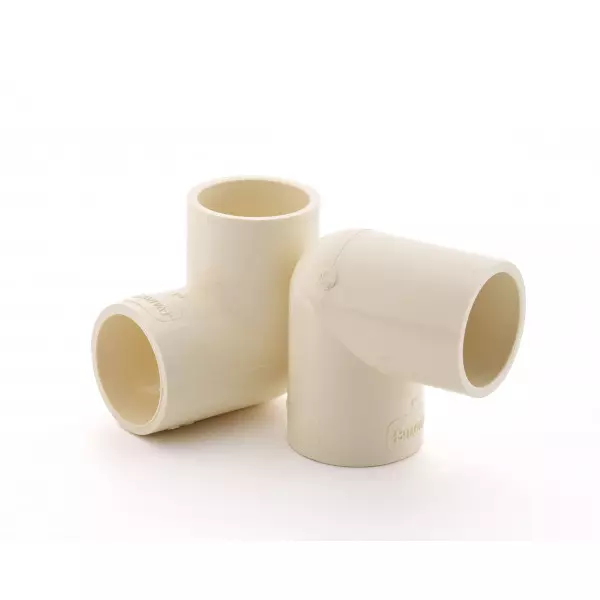 Close-up Of A White CPVC Elbow Fitting Used In Plumbing