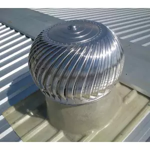 Air Ventilator Turbo Installed On Industrial Rooftop Showing Rotating Fins Against Blue Sky