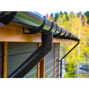 Fiberglass Rain Water Gutter Installed On Commercial Building Roof