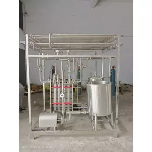 Milk Processing Plant Setup Showing Stainless Steel Tanks And Piping