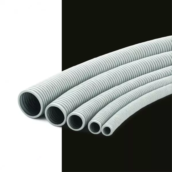 Flexible Plastic Pipe Coiled On Ground Showing Bendability And Smooth Surface