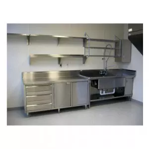 Stainless Steel Commercial Kitchen Setup With Tables And Storage Units