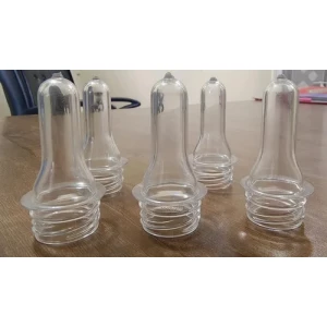 Full Neck PET Preforms Arranged In Rows Showing Consistent Size And Color