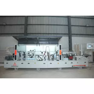 Edge Banding Machine Applying Tape On Wooden Panel In Workshop