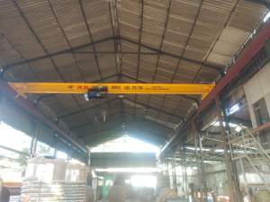 Electric Overhead Crane Lifting Heavy Load In Industrial Warehouse