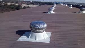 Industrial Roof Ventilator Installed On Factory Rooftop In An Urban Industrial Area