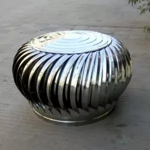 Industrial Turbine Ventilator Installed On Factory Roof Showing Spinning Blades For Airflow