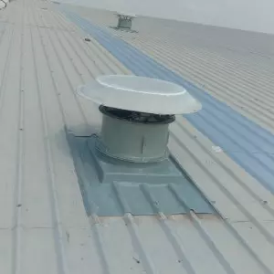 Industrial Roof Ventilator Installed On Factory Rooftop In An Urban Setting