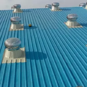 Roof Turbine Ventilator Installed On Factory Rooftop With Clear Sky Background