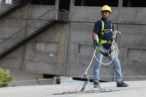 Industrial Worker Using Fall Arrest Equipment At Height