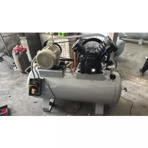 Heavy-duty 200 Pound Air Compressor Unit Installed In An Industrial Setting