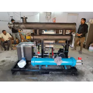 Water Cooled Chiller Unit Installed In An Industrial Setting Showing Pipes And Control Panel