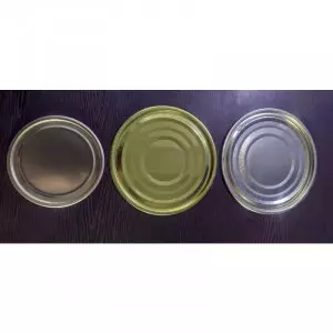 Various Sizes Of Tin Containers Stacked In Warehouse